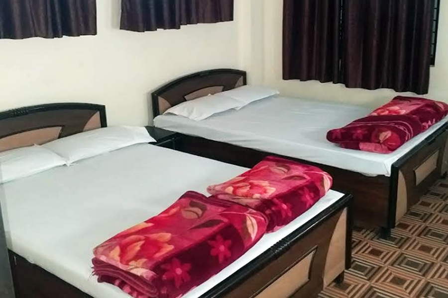 Spacious, bright hotel room with a large bed and desk area